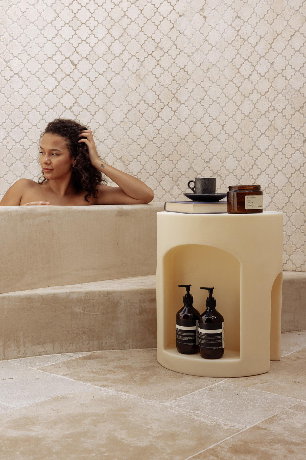 Using the Chapter One Shower Stool as a side table beside the bath